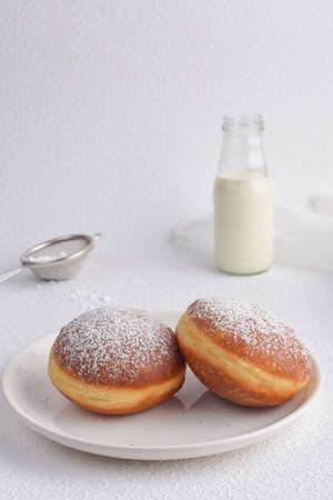 Jelly donuts with apricot jam and milk