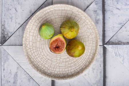 Fresh figs on the white plateの写真素材