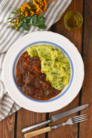 Delicious game ragout with mashed potato and white wineの写真素材