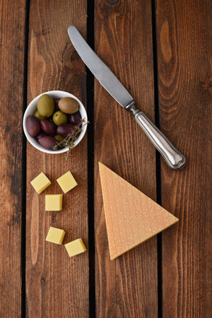Cheese cubes with olives on the wooden tableの写真素材