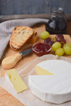 Camembert with grapes and wine, cheese plateの写真素材