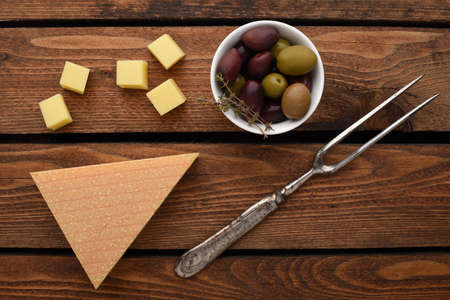 Mountain cheese cubes with rosemary, black and green olivesの写真素材