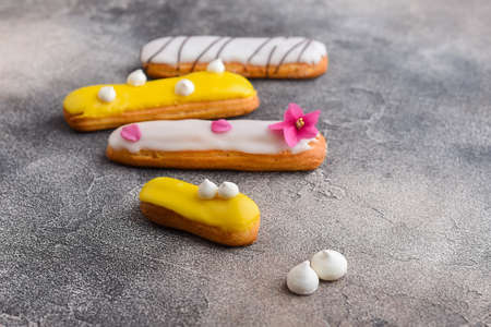 Homemade mini mango and vanilla eclairs with meringueの写真素材