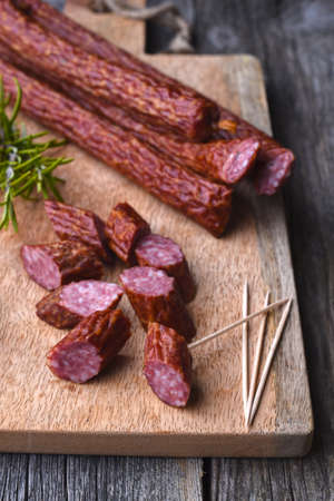 Game sausage with rosemary on the wood backgroundの写真素材