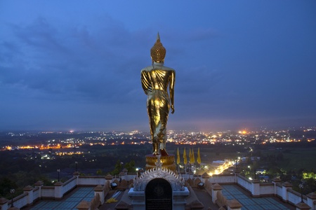 Buddha Standing Color Gold in Background blue sky.の写真素材
