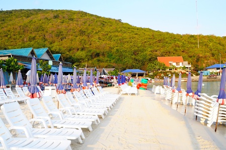 Beach chair and colorful umbrella on the beachのeditorial素材