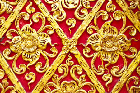 The gold stucco design of native thai style on the Wallの写真素材