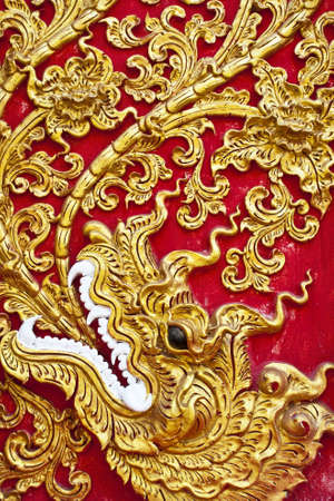 The gold stucco design of native thai style on the Wall