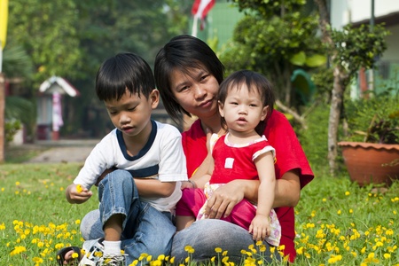 Asian Family in green Lawnの写真素材