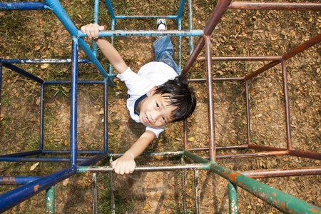 Asian Kid Playing In Playgroundの写真素材