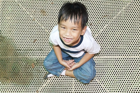 Asian Kid Playing In Playgroundの写真素材