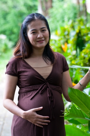 beautiful pregnant mother to be in natureの写真素材