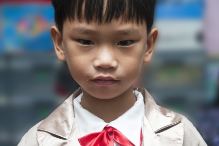 Little boy with brown tuxedo and red bow tieの写真素材