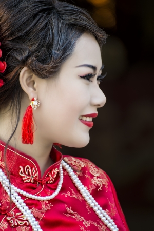 Chinese girl in traditional Chinese cheongsam blessingの写真素材