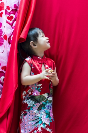 China girl in traditional Chinese red Tang suit greetingの写真素材