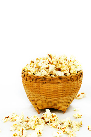 Popcorn in a wooden bucket on white backgroundの写真素材
