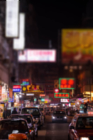 blurred image of people moving in night cityの写真素材