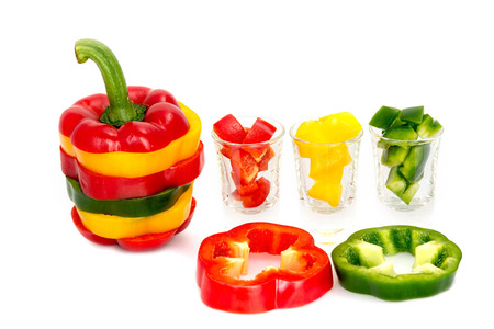 Three colored red Yellow green  bell pepper vegetarian recipe paprika spice isolate on white...