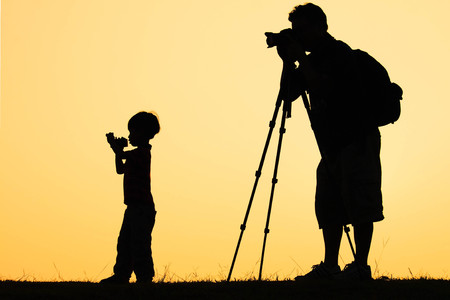 silhouette of photographer shooting photo for a sunriseの写真素材
