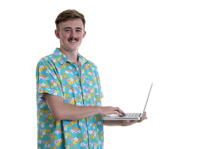 Young man in Hawaii dress with tablet computer during tropical beach vacation