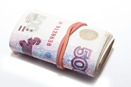 Mounds of loose bills, isolated on white.の写真素材