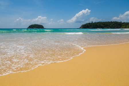 Beautiful sea Sunny landscape on the beach. Light waves of blue color spread all over the beach smoothly smoothing the Golden sand.の写真素材