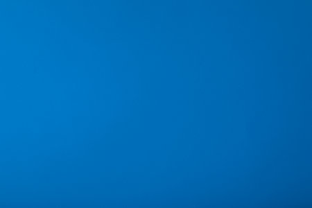 Blue background with paper texture, horizontal, blank space.の写真素材