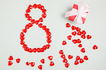 March 8, composition of hearts on a blue background. View from above. Space for text, flat lay