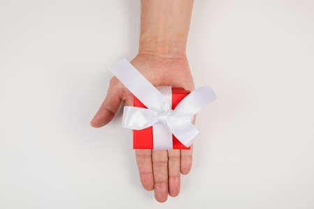 Gift box in men's hands for a holiday. View from above. Flat layの写真素材