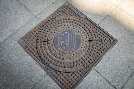 Dresden, Germany, April 18, 2018: Manhole cover made of cast iron of the city sewer system of Dresden.のeditorial素材