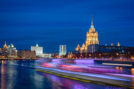 A ship with blurred lights moves along the river against the background of the evening city. Long exposure time. Moskow Russia 1025 June 2019のeditorial素材