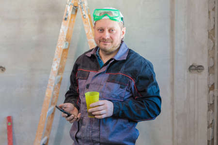 An electrician drinks tea during his lunch break at the enterprise.
