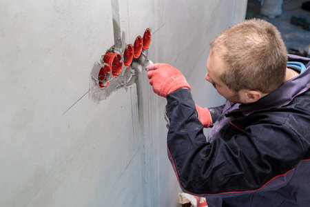 The electrician will plaster holes and channels for sockets and wires.