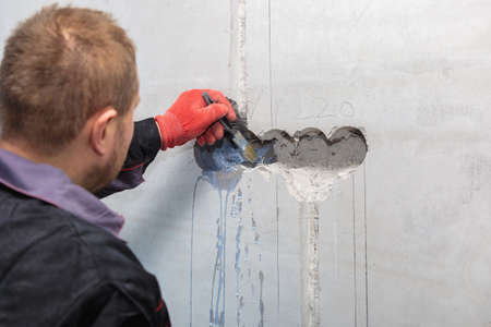 The electrician will prime the holes and channels for outlets and wires.