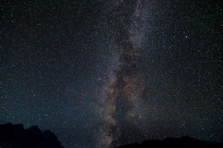 Starry sky and the Milky Way with bright stars over the mountains of North Ossetia.