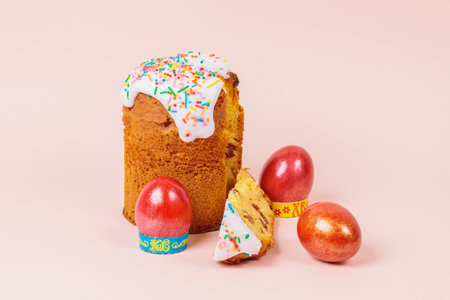Easter. Easter cakes with eggs and bunny ears on a pink background. Easter. Vase with flowering branches.の写真素材