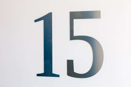 Number 15 on the wall, carved out of light metal. Floor designationの写真素材