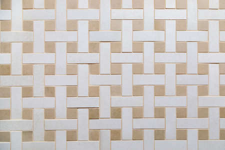 The texture of beige ceramic tiles with a weaving pattern.の写真素材