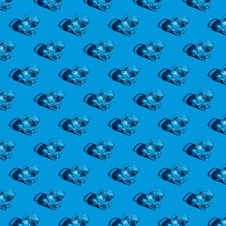 Seamless pattern of glasses with water on a blue background.の写真素材