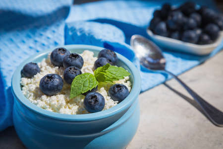 Morning fresh breakfast made from natural products from cottage cheese and blueberries.