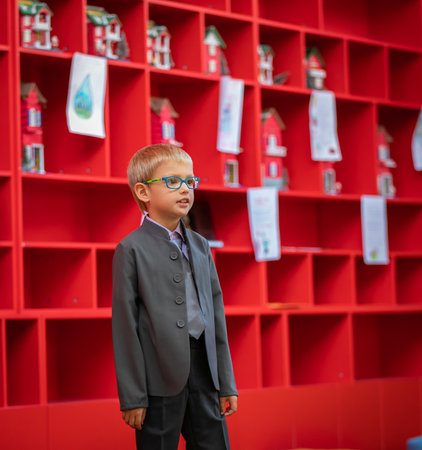 A boy with glasses, a first grader, speaks to a children's audience in the class. Acquaintance with the school. Moscow, Russia, September 2, 2019のeditorial素材