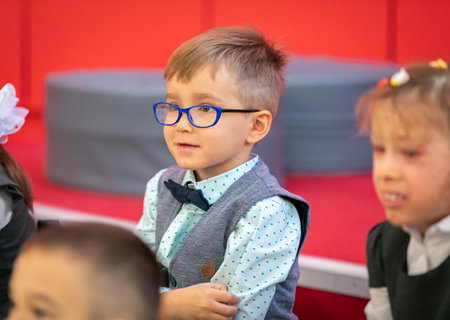 Children sit at their desks in class on September 1. First graders listen carefully to the teacher in the first lesson. Moscow, Russia, September 2, 2019のeditorial素材