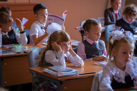 Children sit at their desks in class on September 1. First graders listen carefully to the teacher in the first lesson. Moscow, Russia, September 2, 2019のeditorial素材