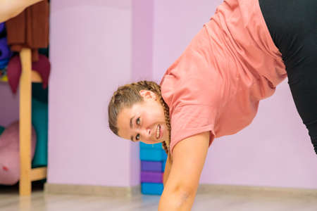 The girl dance instructor shows the elements of the act in front of the mirror.の写真素材
