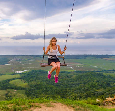 A woman swings on a swing on a high mountain in the Dominican Republic. tourist place. high quality...