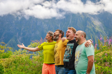 A group of friends are relaxing in the mountains, screaming with pleasure. Mountains of the Caucasus. Russia Ossetia Vladikavkaz August 15, 2020.のeditorial素材