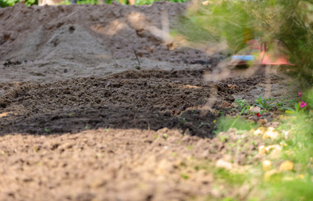 Plowed land, agricultural work. Leveling the soil on the site.Close-up.の写真素材