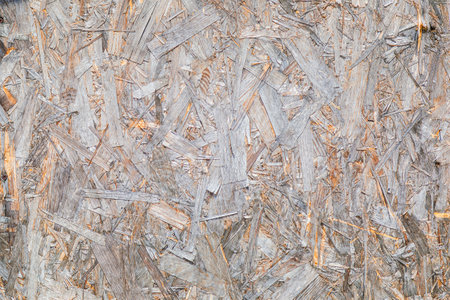 OSB material texture is a board made from recycled pressed wood shavings. Chipboard from large wood...