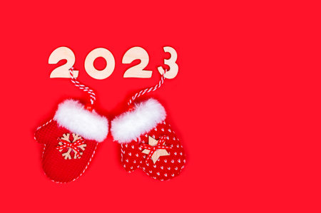 Creative background of new year 2023 numbers with holiday mittens. Postcard, congratulations, bannerの写真素材