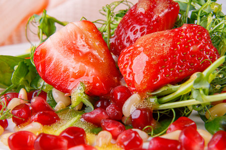 Salad with microgreens, strawberries, pine nuts and pomegranate seeds. Close-up.の写真素材